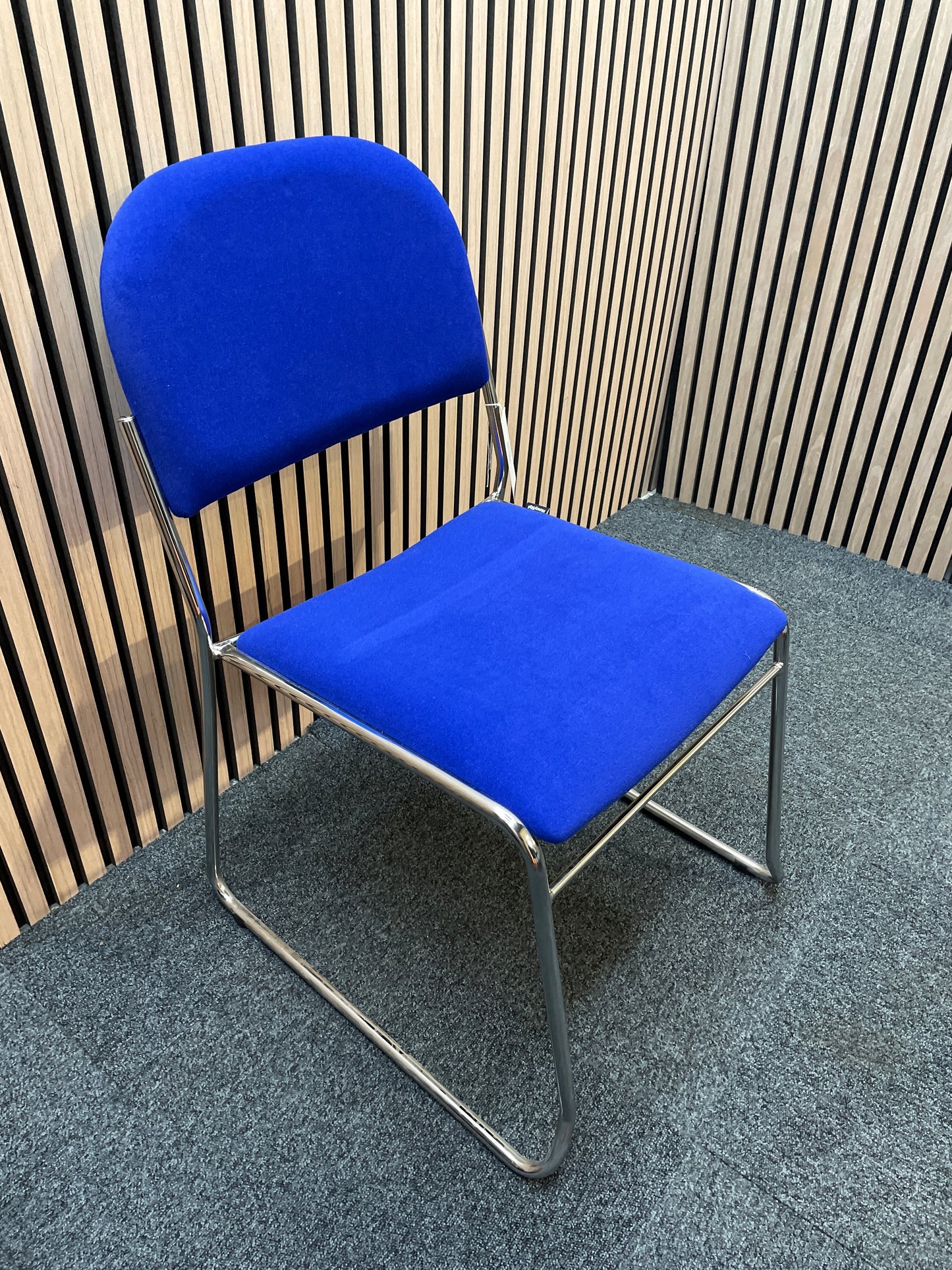 Jive fabric stacking chair with solid frame in blue- no arms