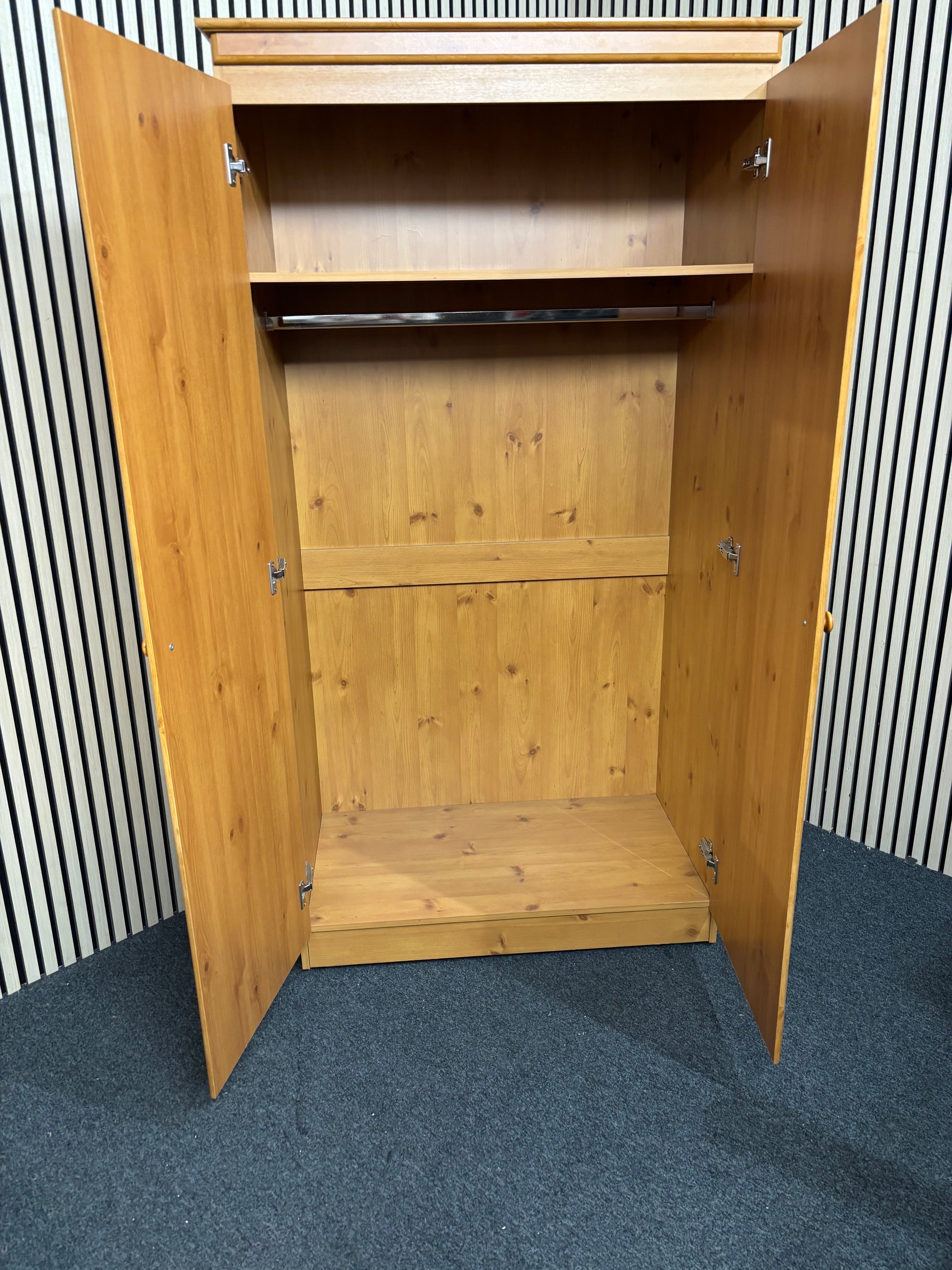 Solid pine wooden wardrobe with two paneled doors and round knobs