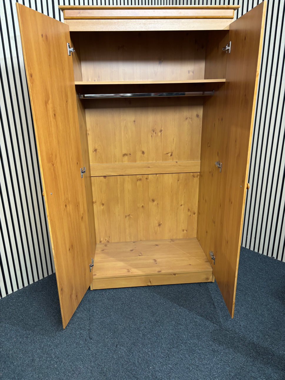Solid pine wooden wardrobe with two paneled doors and round knobs
