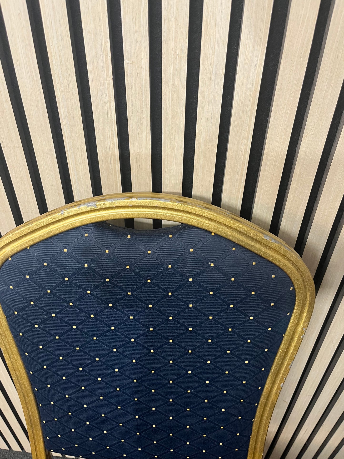 Blue patterned fabric banquet stacking chair with gold effect metal frame