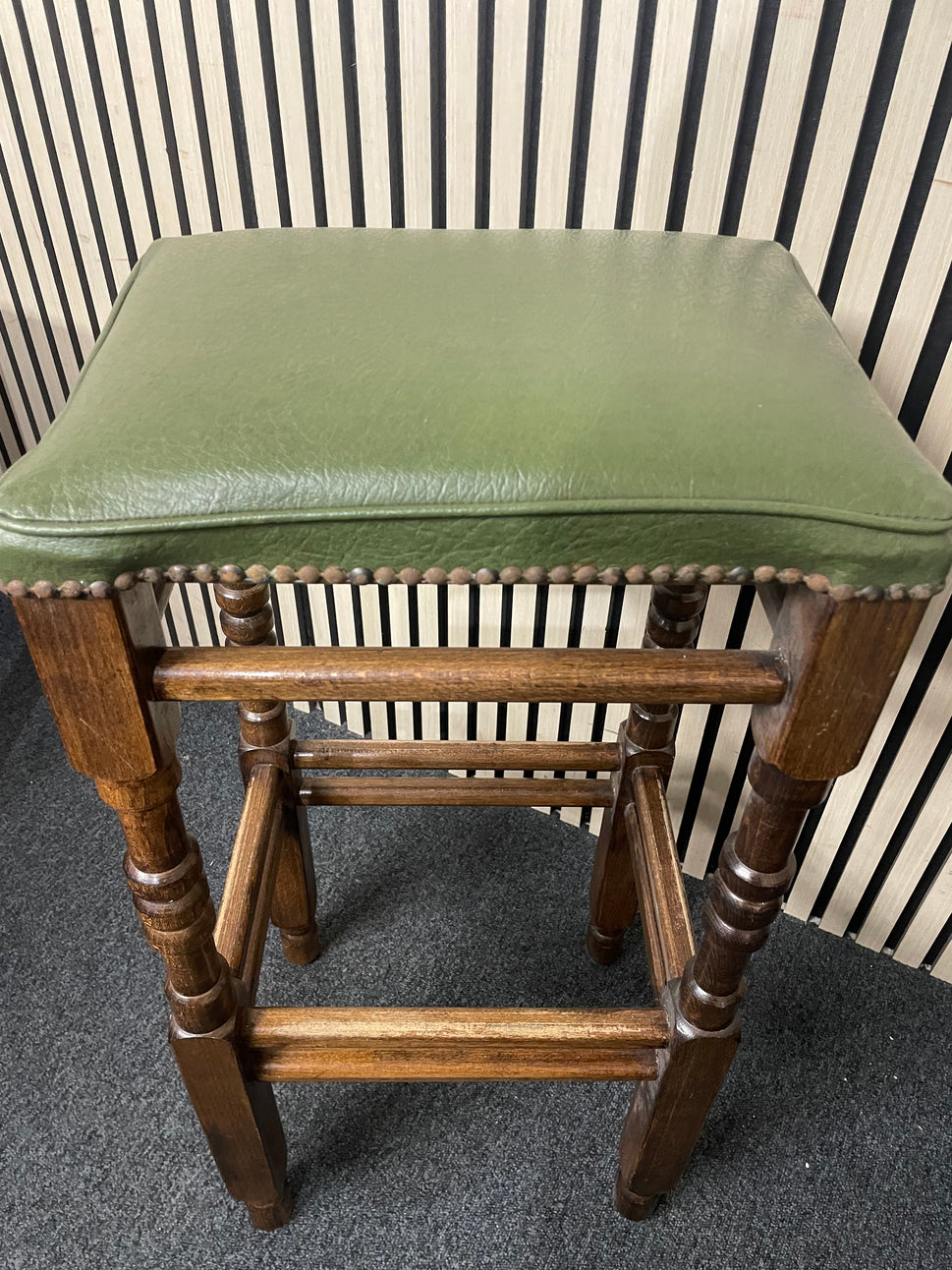 Ornate solid wooden framed high bar stool with green leatherette seat and button design 1126