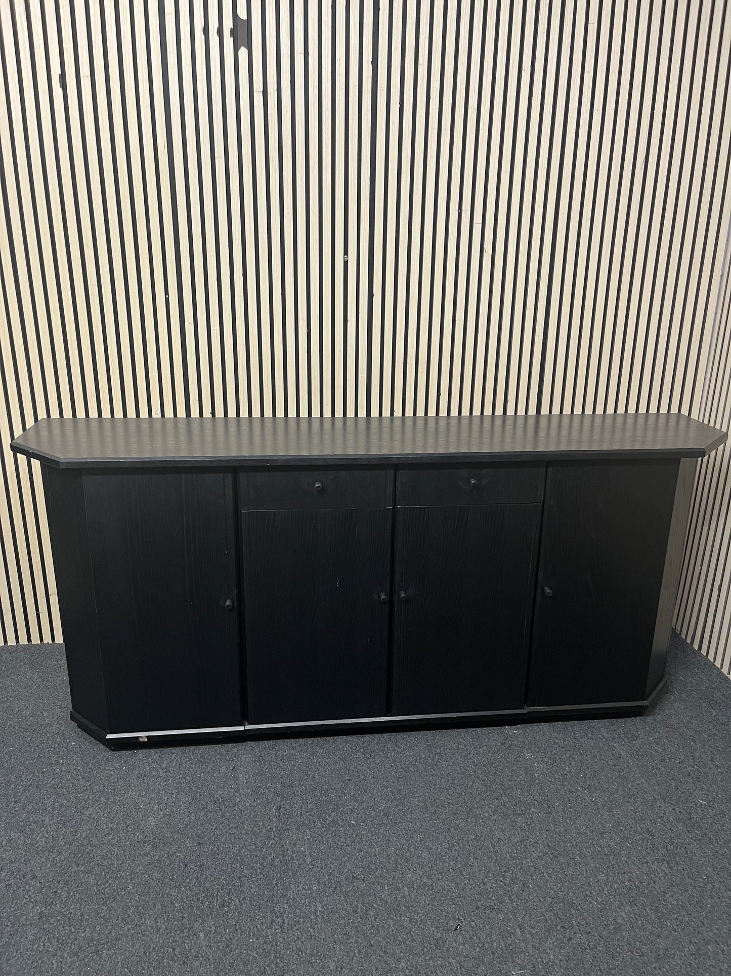 Black low sideboard with three storage doors, good condition. 44030