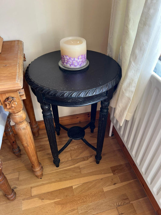 Ornate black painted circular occasional table 