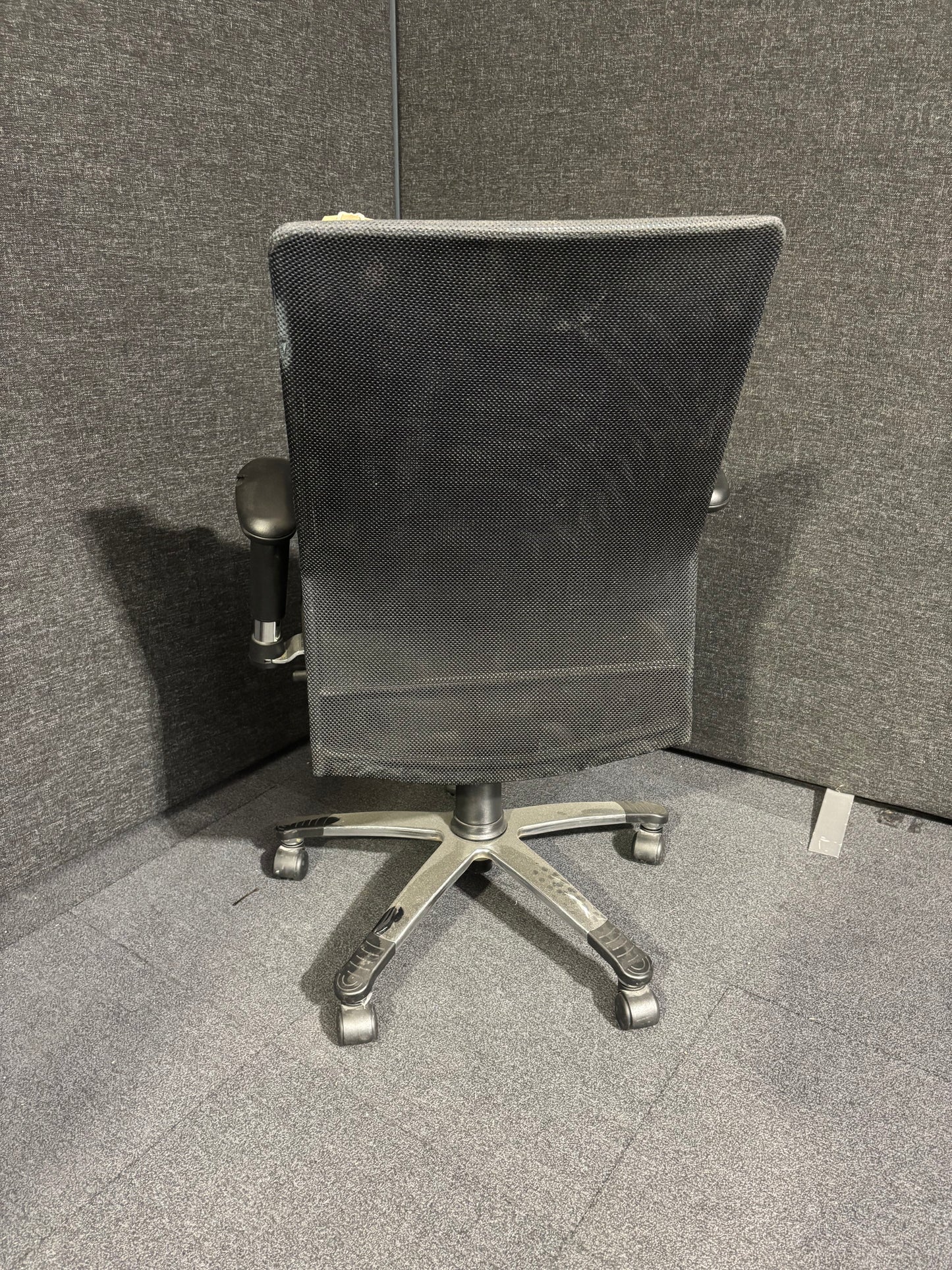 High back black leather and mesh executive swivel chair with polished metal base and height adjustable arms