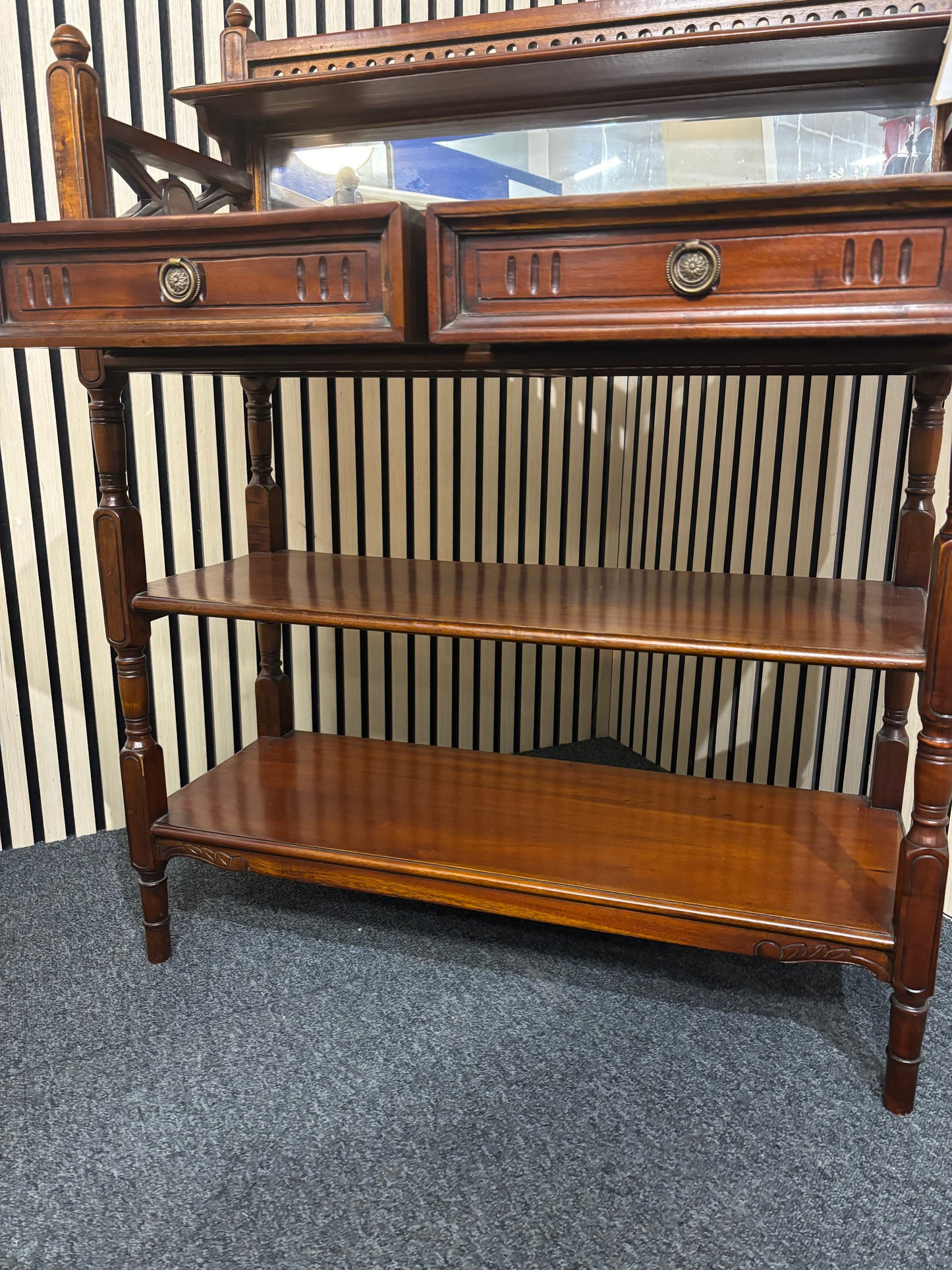 Ornate mahogany framed open bookcase with detailed carving and framed mirror back with 2 drawers (H 105 x W 80 x D 32 cm) 2325