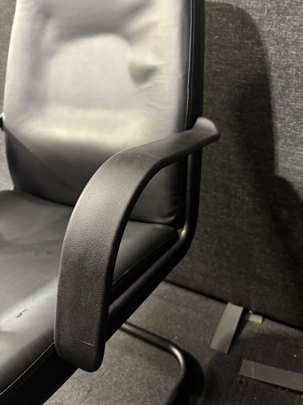 Black leatherette black metal framed meeting chair with fixed arms