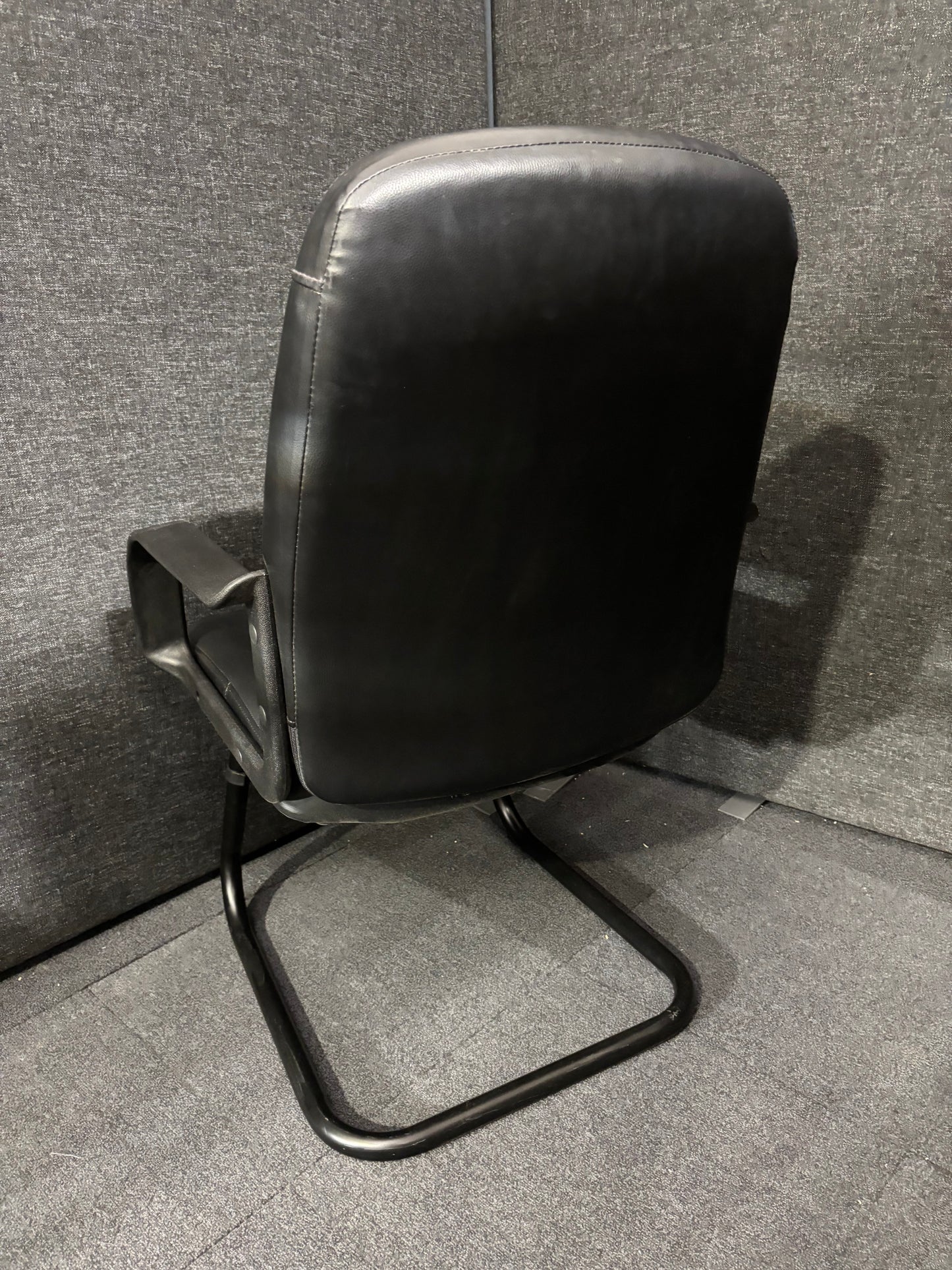 Black leatherette black metal framed meeting chair with fixed arms