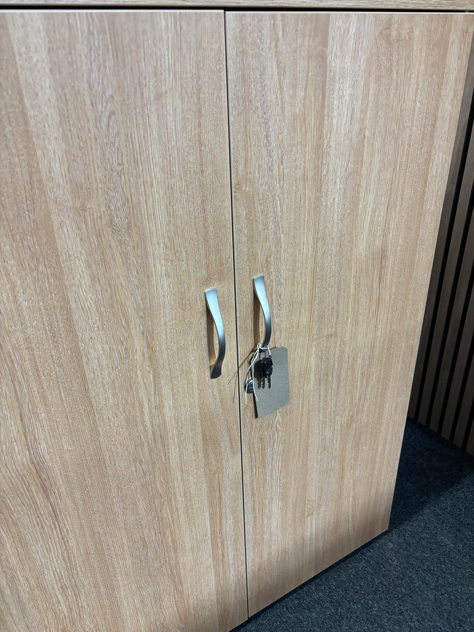 Universal 2 door storage unit in oak laminate with 2 no. internal shelves and key 1090Hx470Dx800W