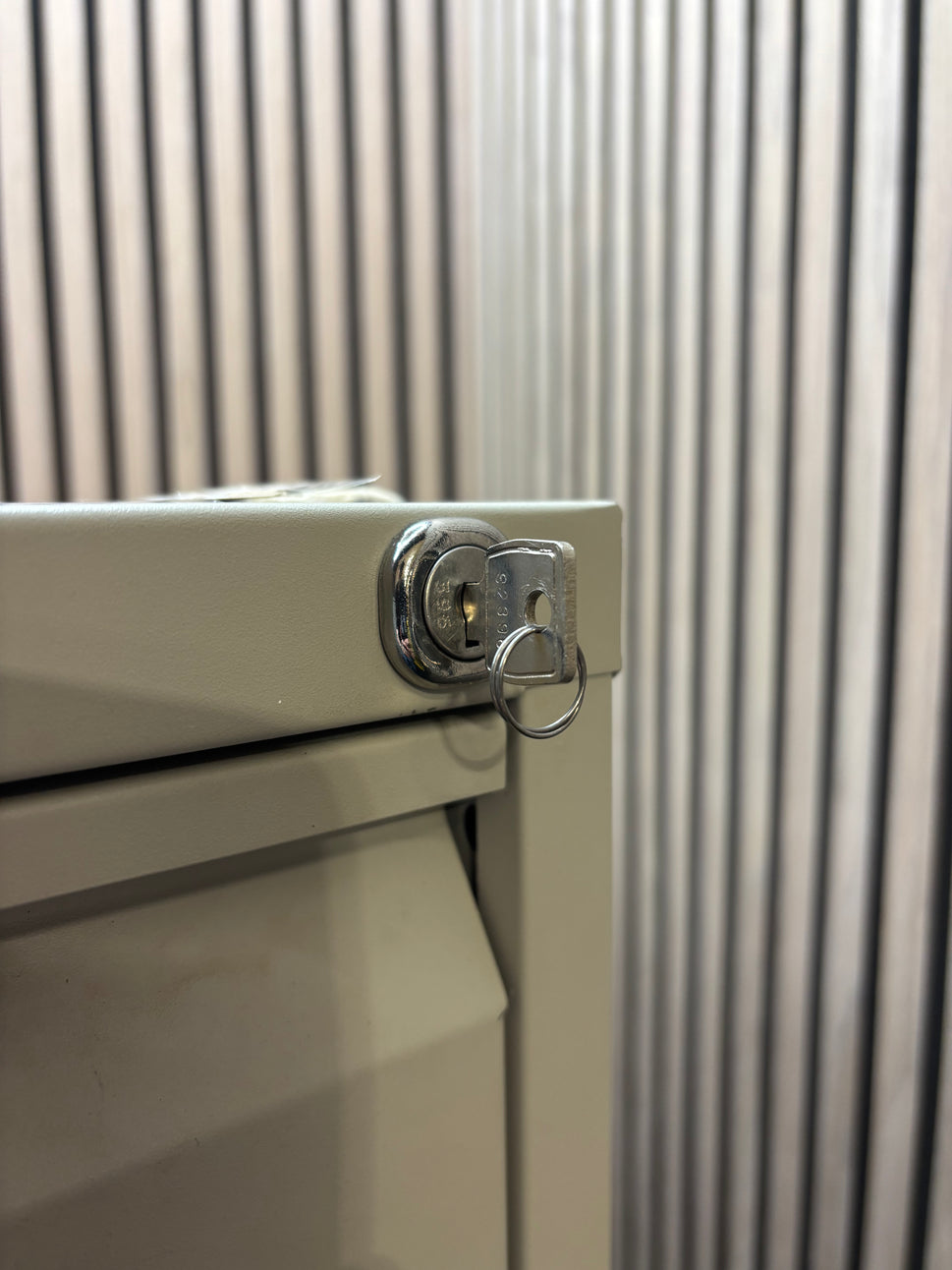 Grey metal 4 drawer filing cabinet with key