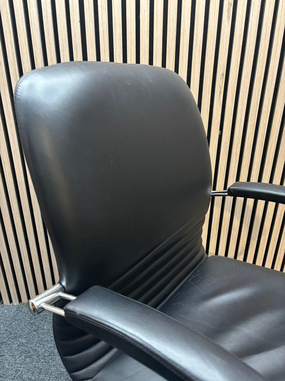 Black leatherette solid metal framed meeting chair with arms