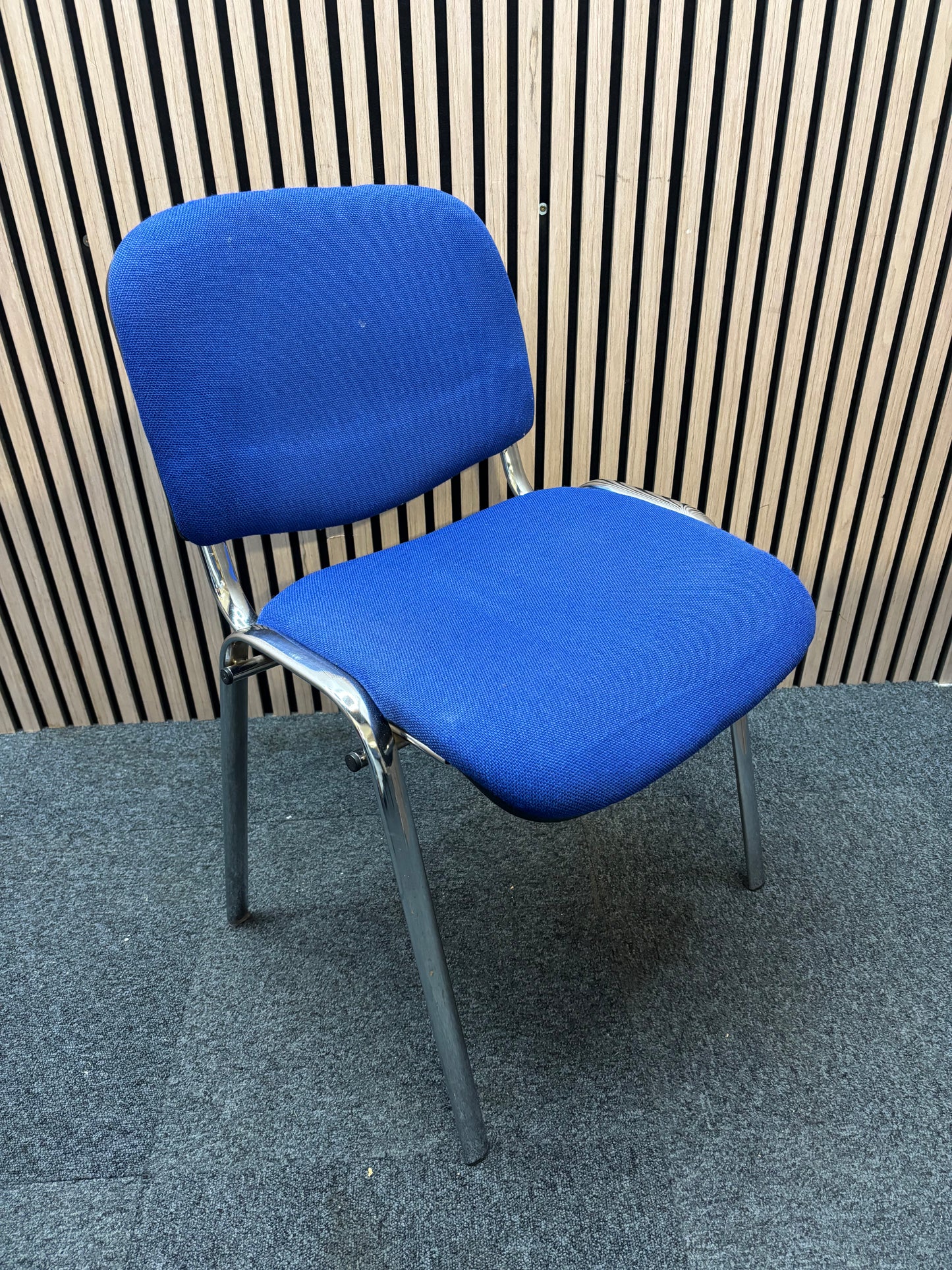 Medium blue fabric chrome framed stacking chair