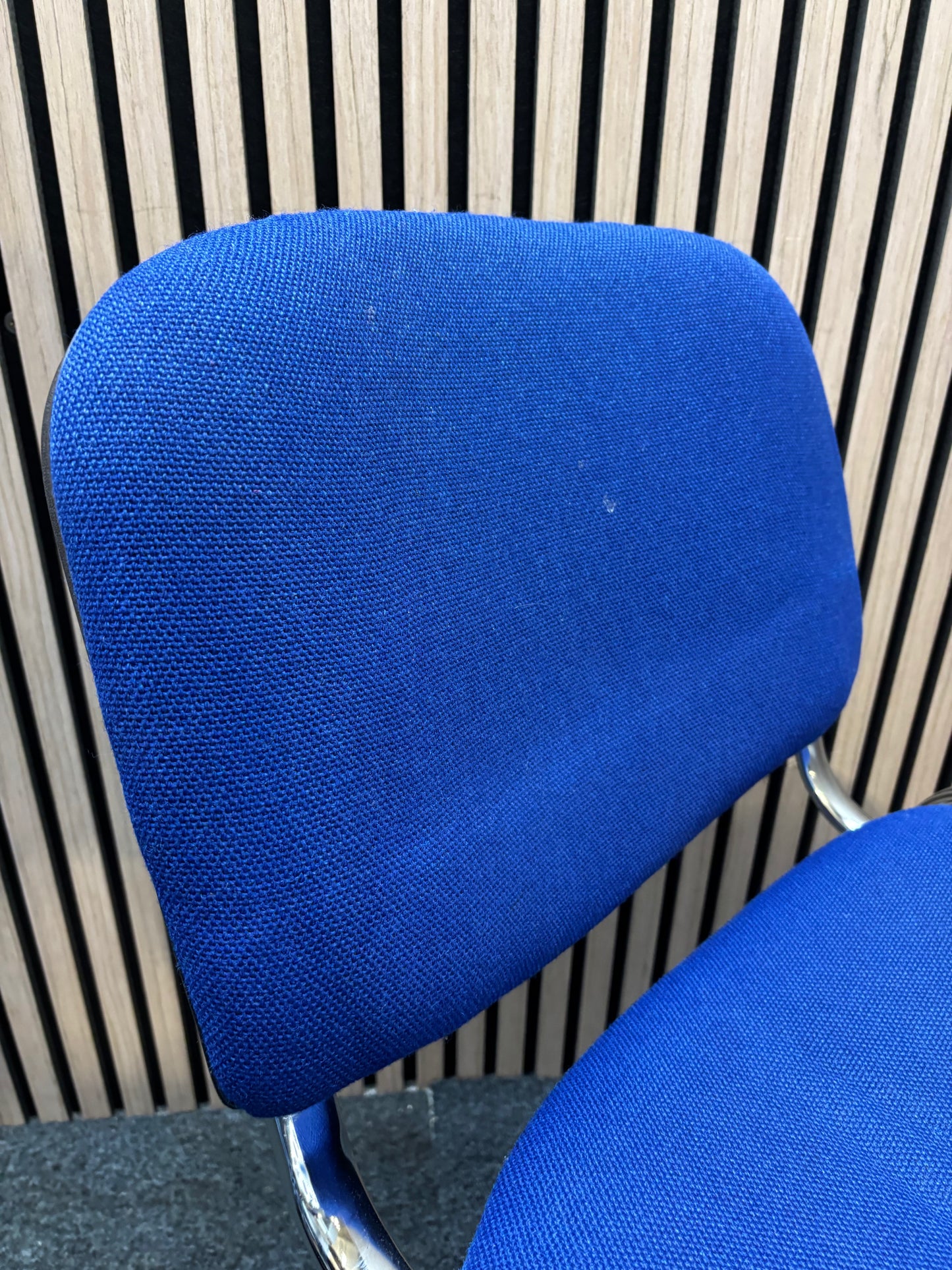Medium blue fabric chrome framed stacking chair