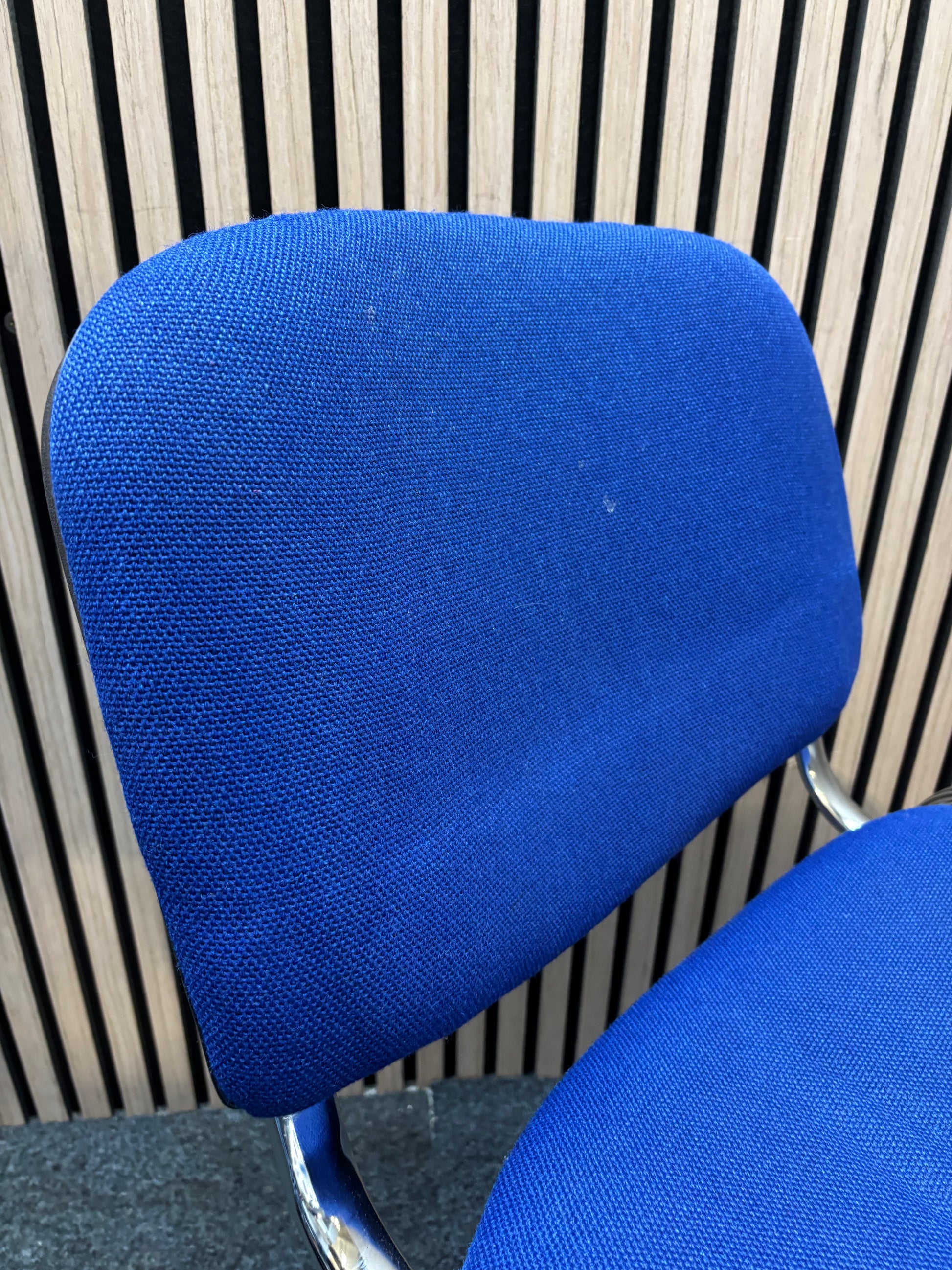 Medium blue fabric chrome framed stacking chair