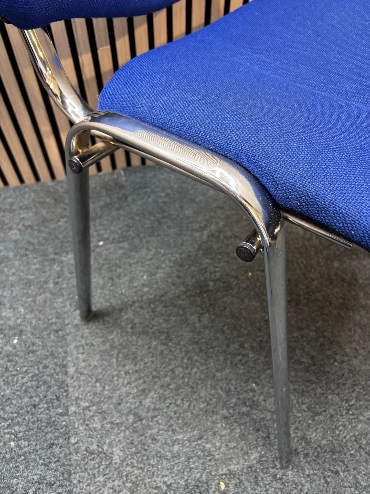 Medium blue fabric chrome framed stacking chair