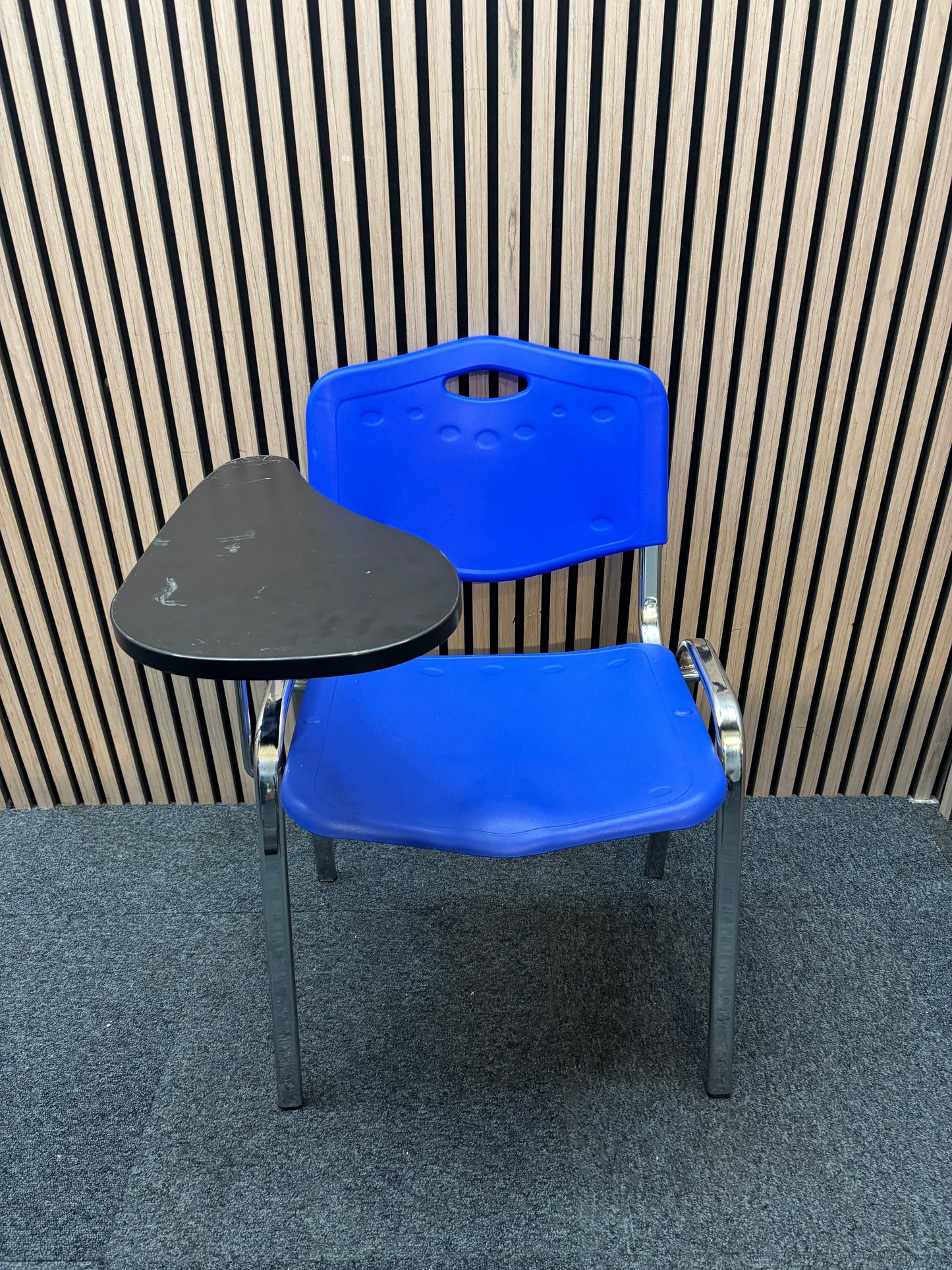 Blue plastic chrome framed stacking chair with removable writing tablet