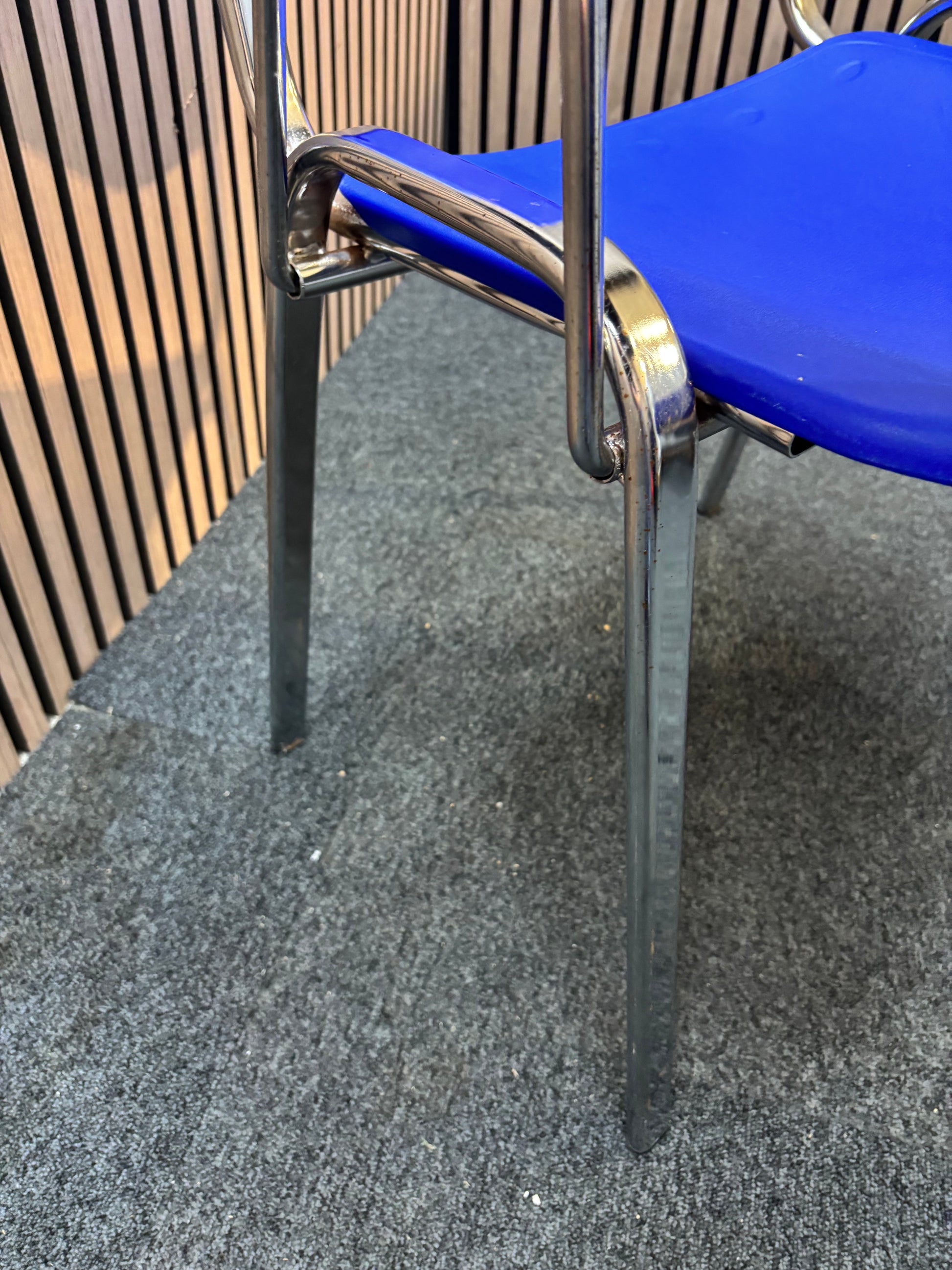 Blue plastic chrome framed stacking chair with removable writing tablet