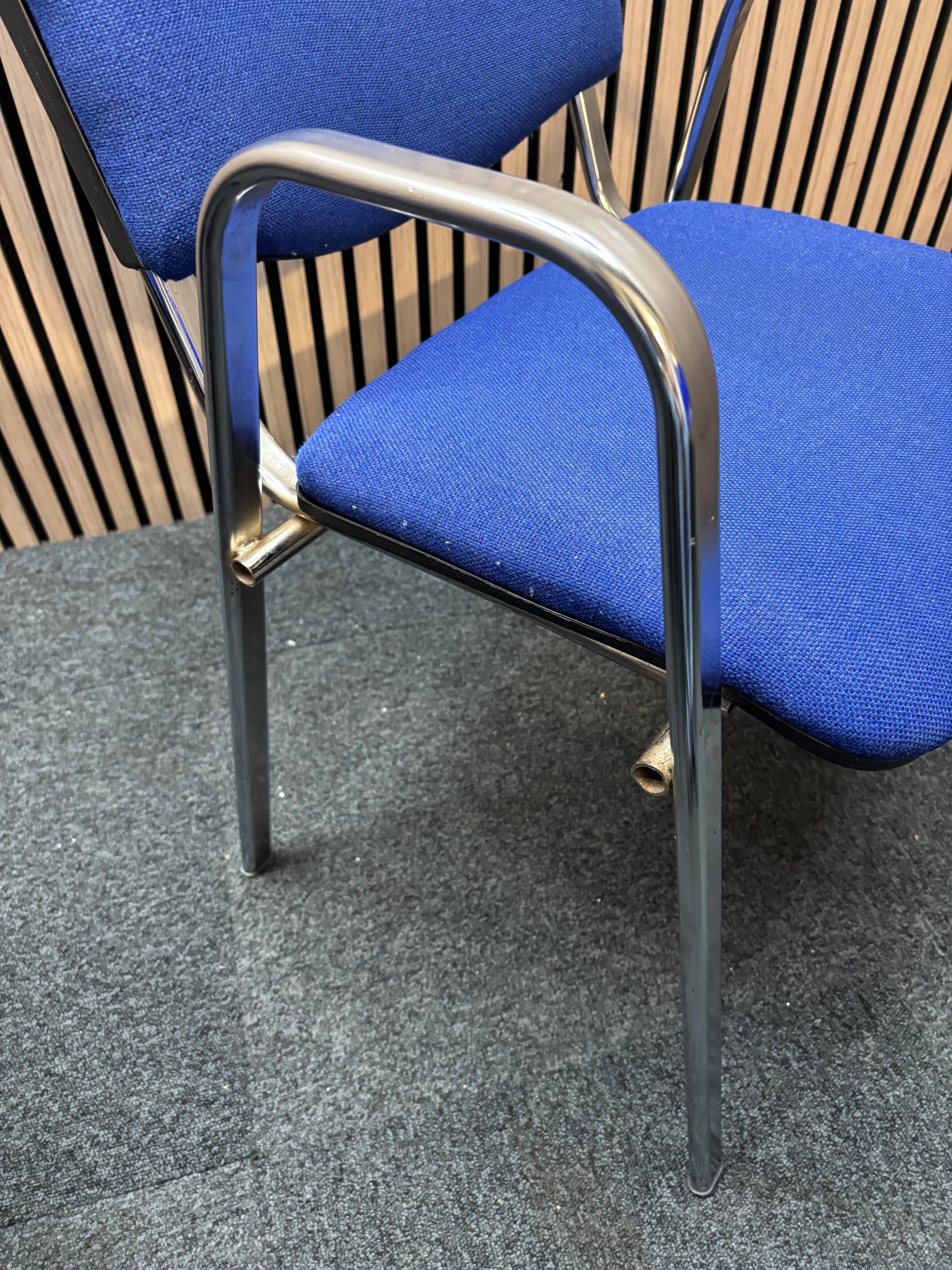 Light blue fabric chrome frame stacking chair with arms