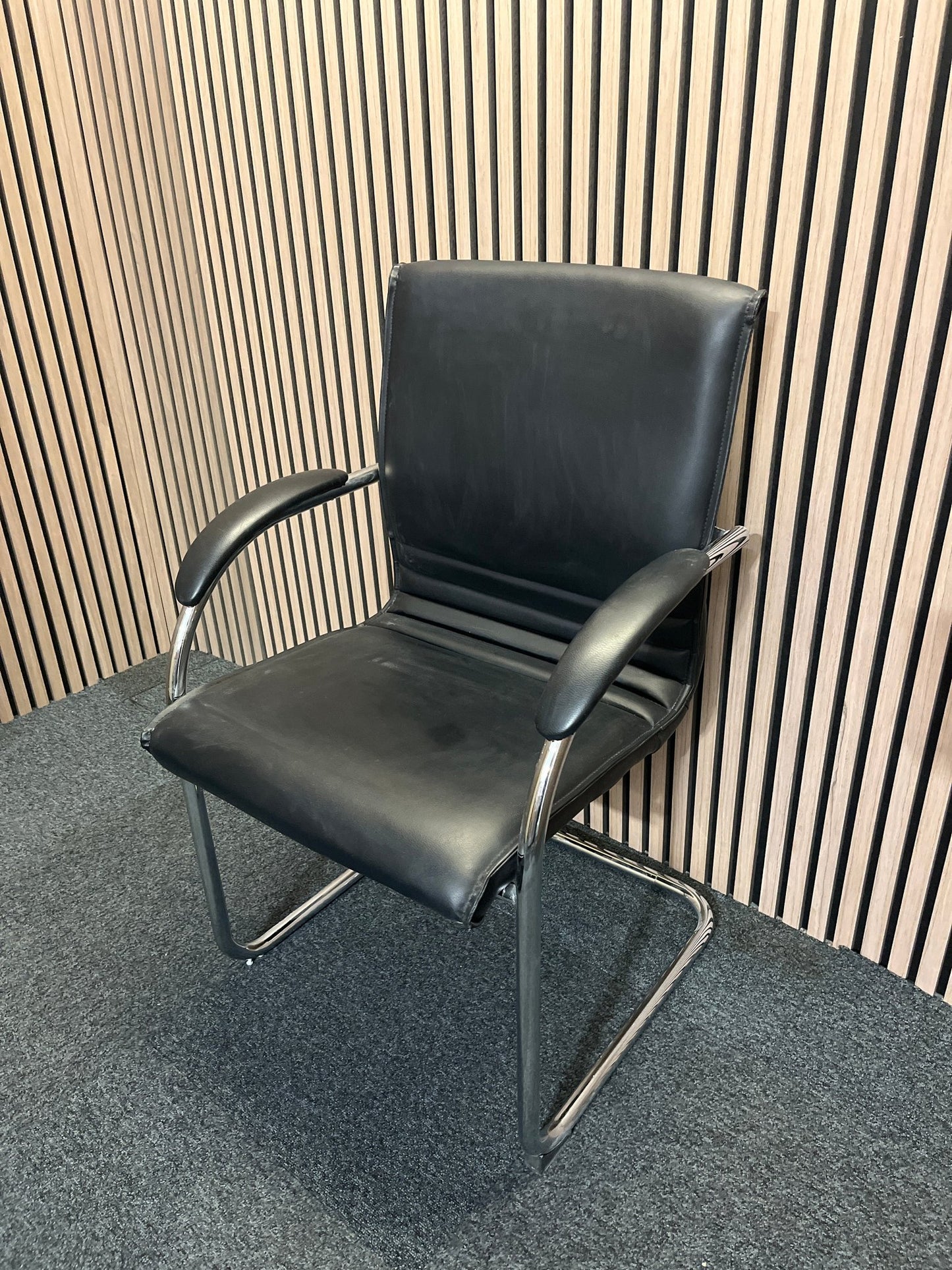 Black second hand leather boardroom chair with cantilever frame