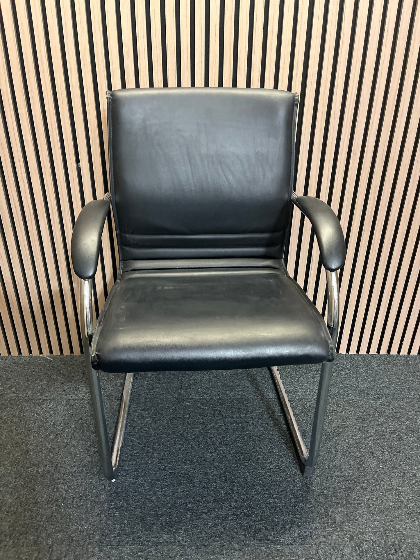 Black second hand leather boardroom chair with cantilever frame