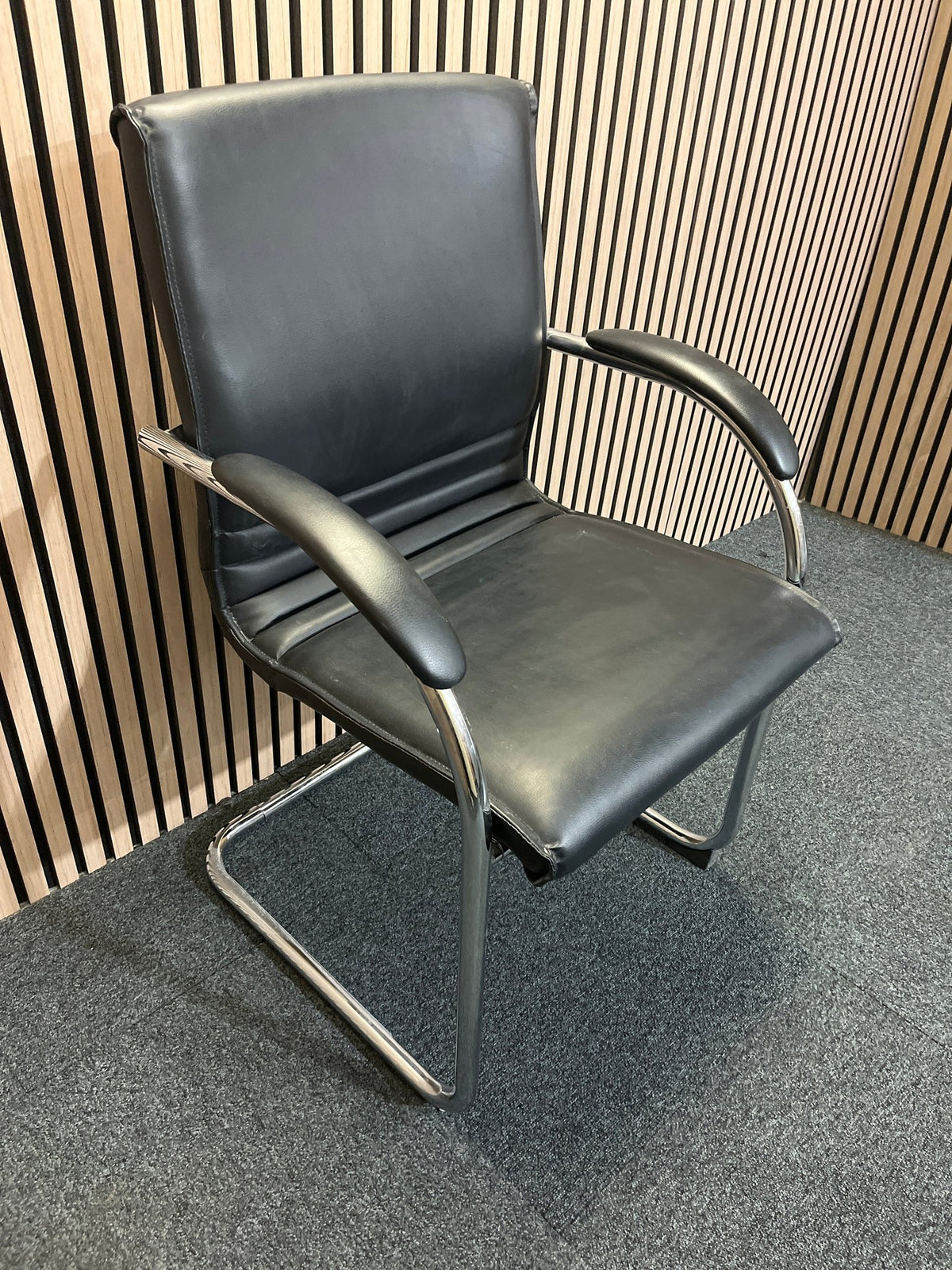 Black second hand leather boardroom chair with cantilever frame