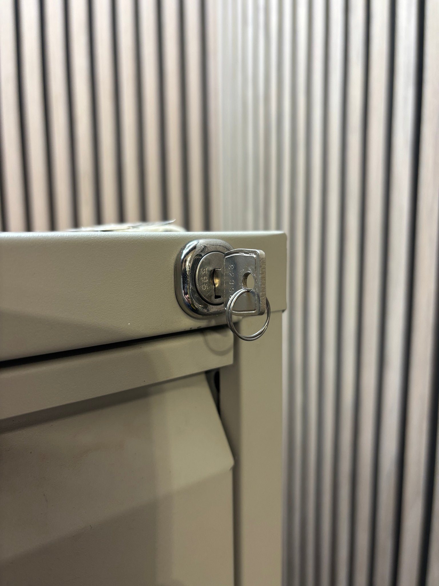 Grey metal 4 drawer filing cabinet with key