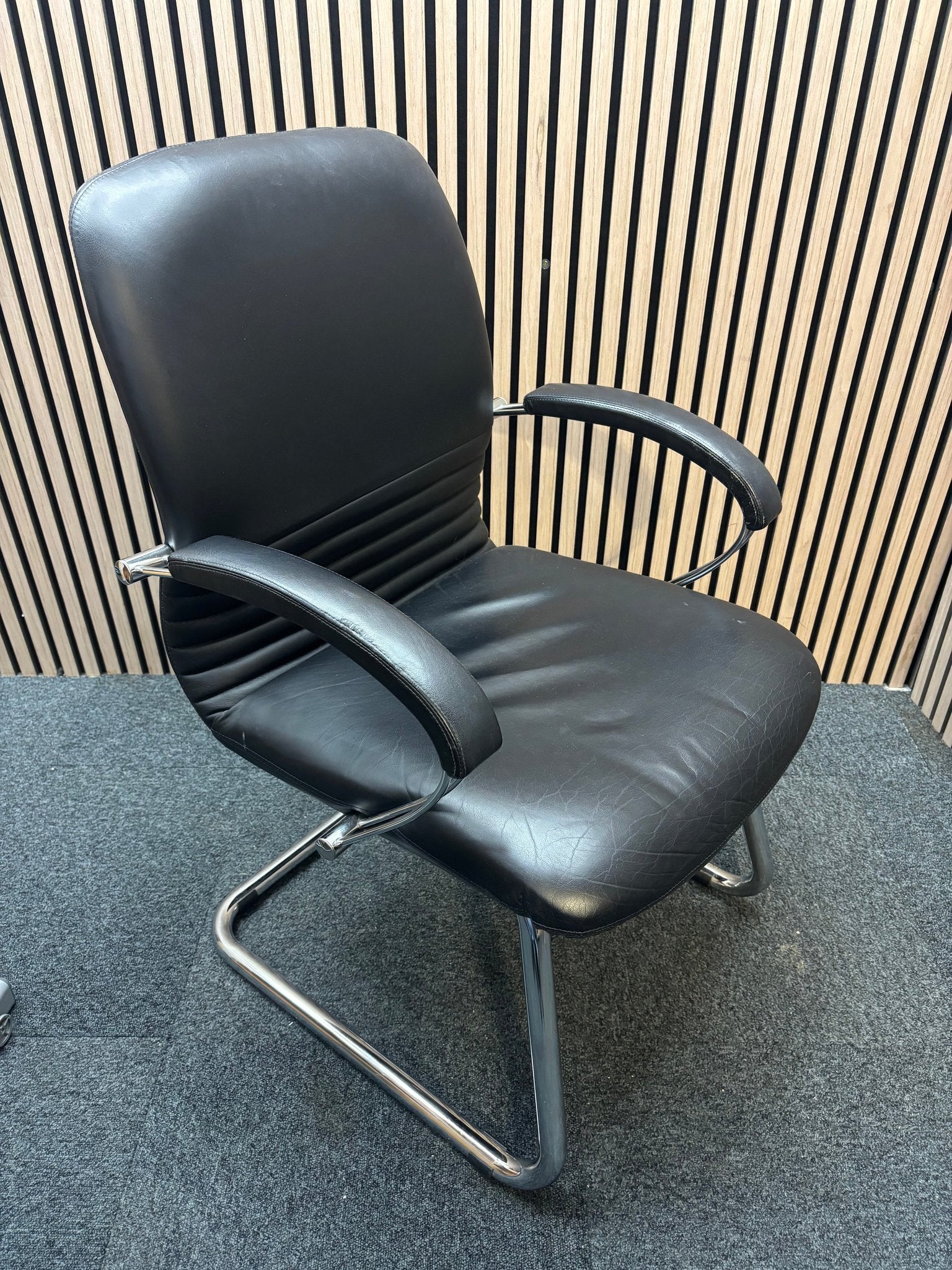 Black leatherette solid metal framed meeting chair with arms
