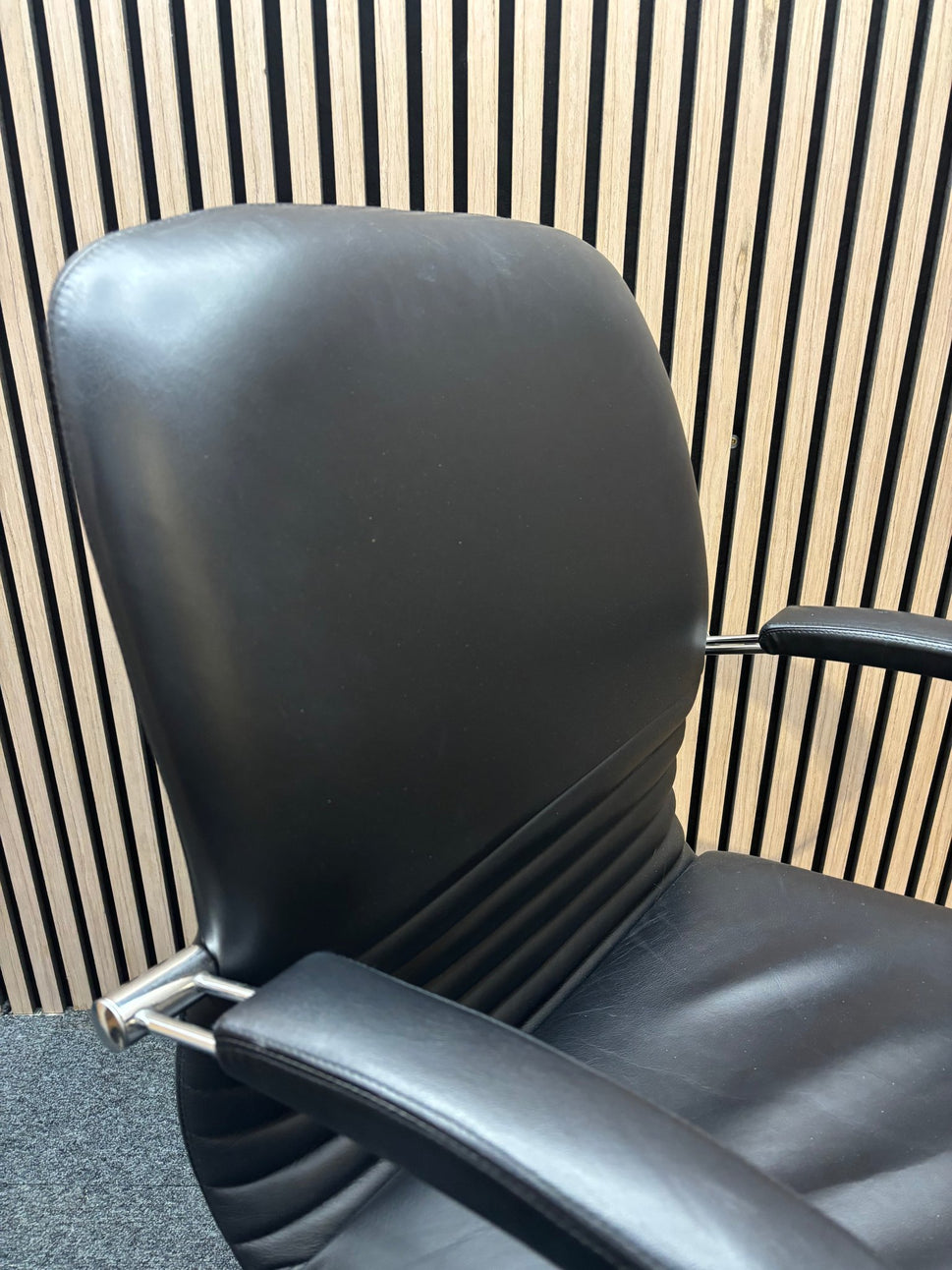 Black leatherette solid metal framed meeting chair with arms