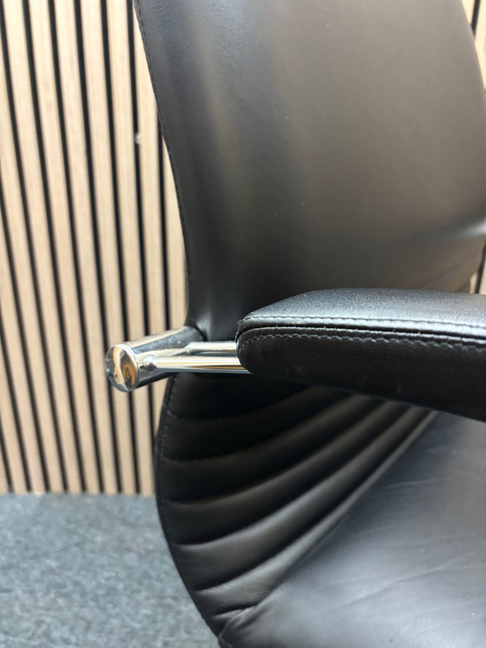 Black leatherette solid metal framed meeting chair with arms