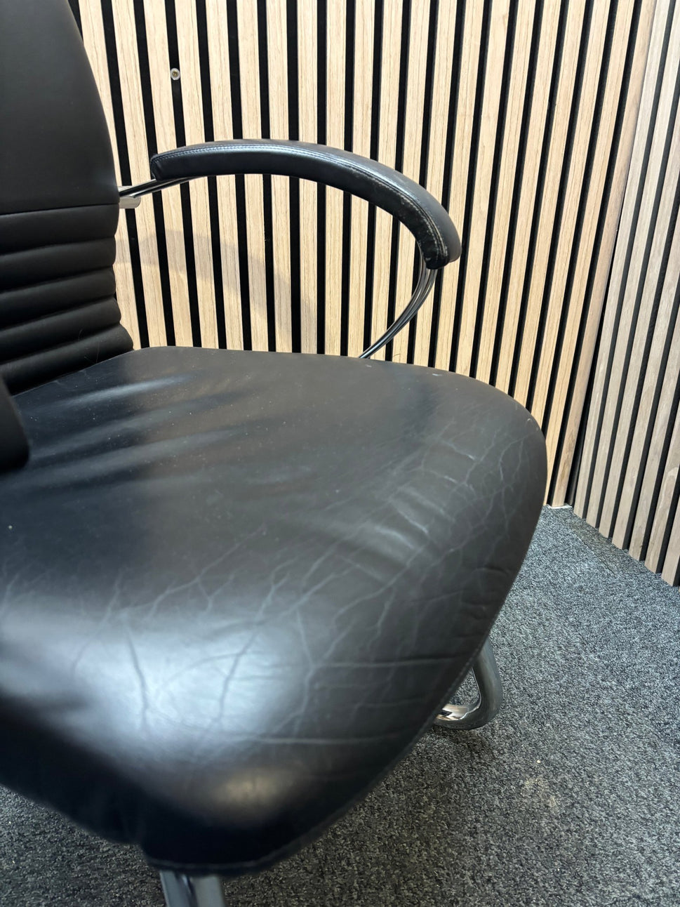 Black leatherette solid metal framed meeting chair with arms