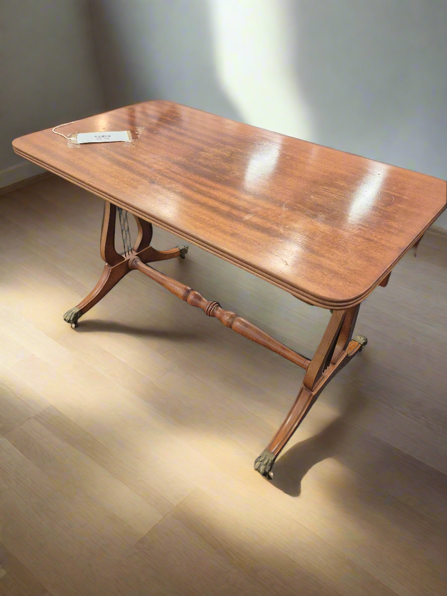 Low ornate mahogany coffee table on brass castors  3125