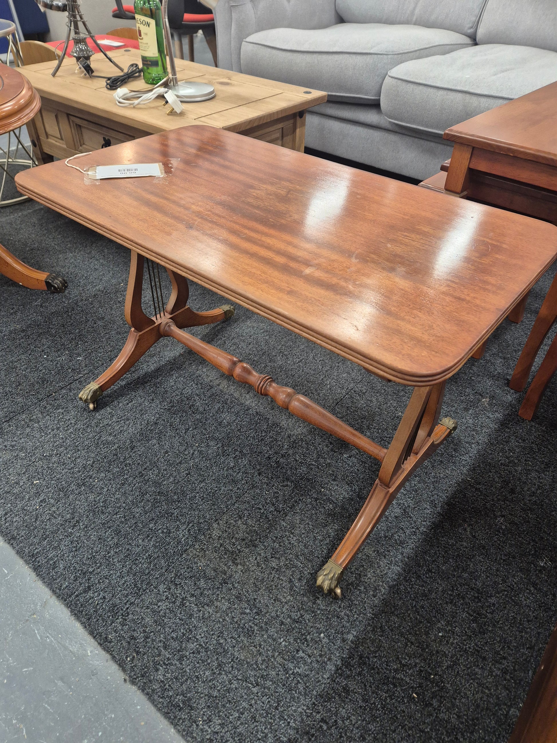 Low ornate mahogany coffee table on brass castors  3125
