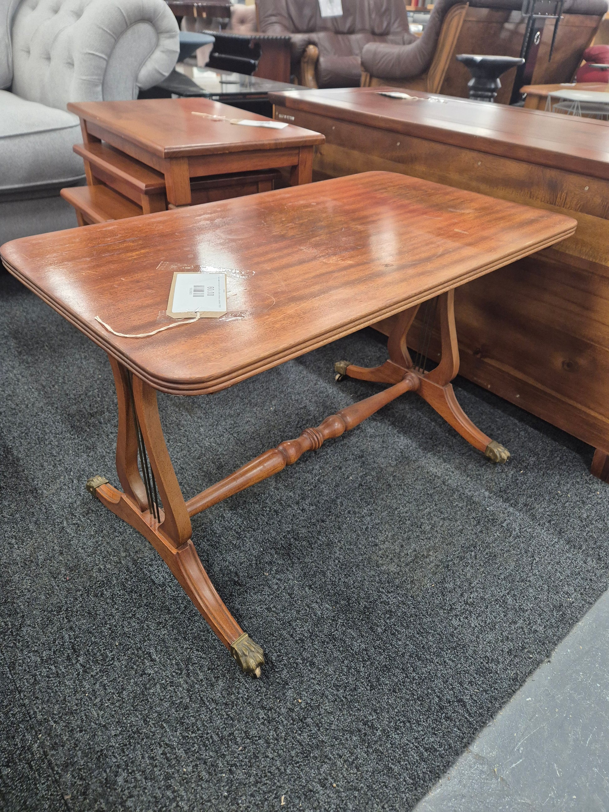 Low ornate mahogany coffee table on brass castors  3125