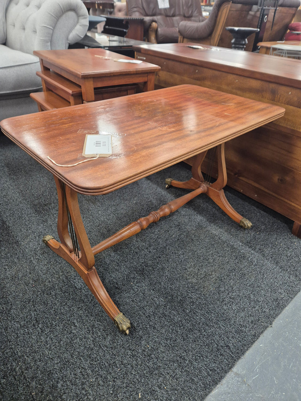 Low ornate mahogany coffee table on brass castors  3125