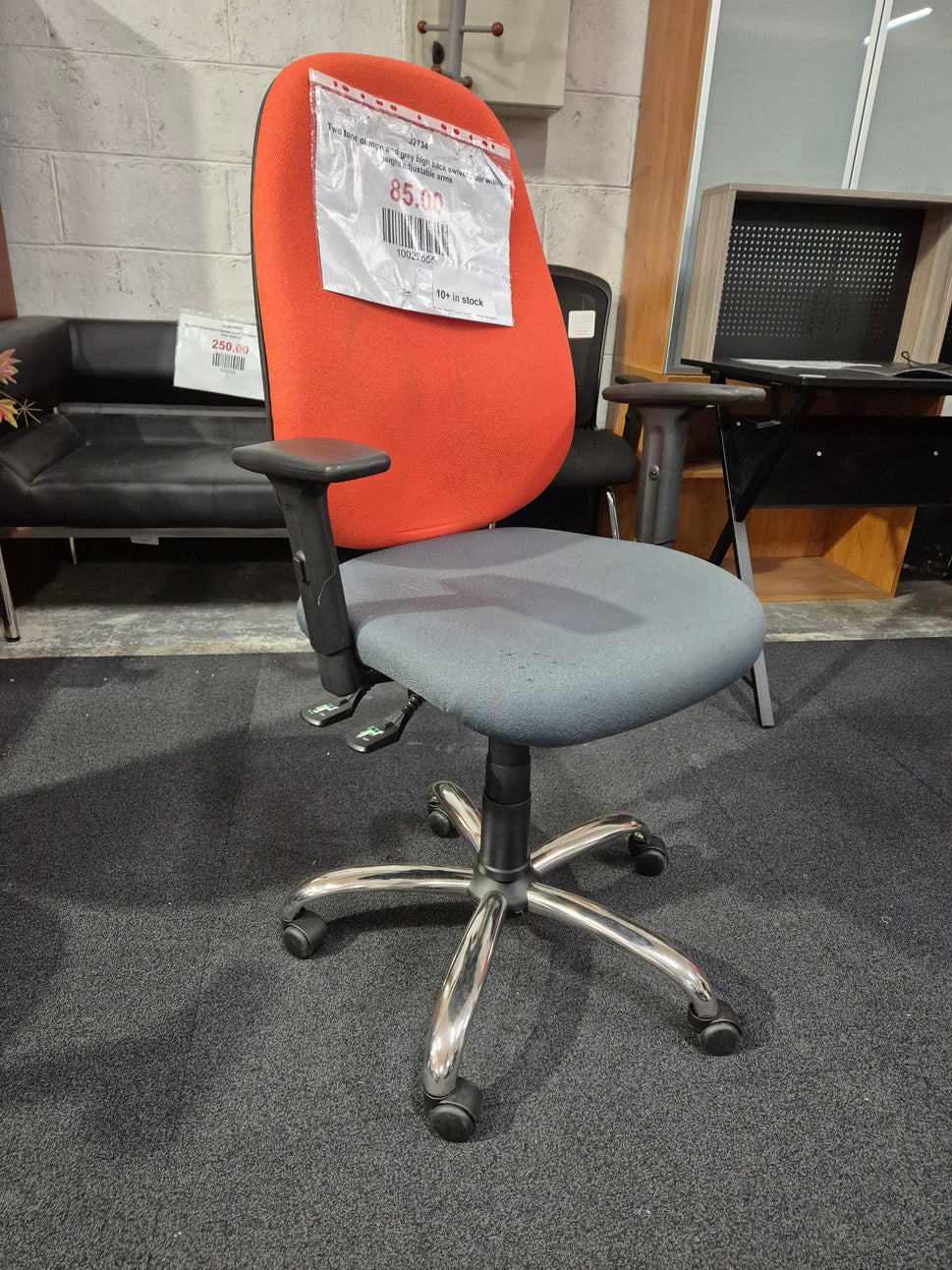Two tone orange and grey high back swivel chair with height adjustable arms