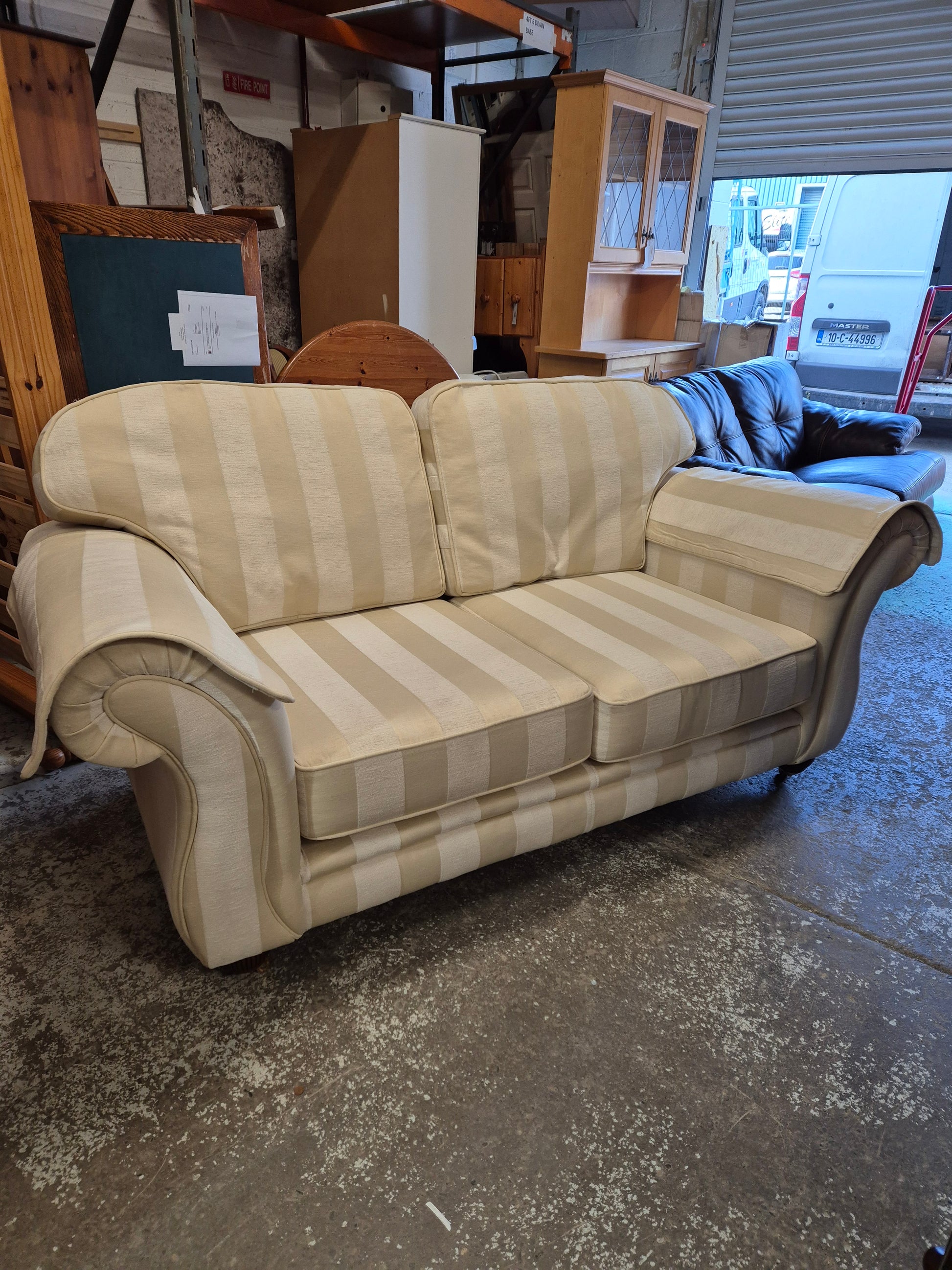 2 seater Finline roll back sofa in cream stripe fabric with brass castor legs  2125